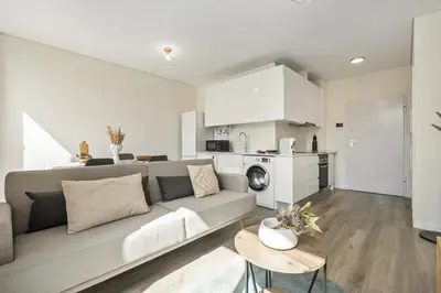 a living room with a couch and a kitchen at Carmo Charm Apartment by Homie in Funchal