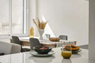 a table with a bowl of food and a glass of orange juice at Carmo Charm Apartment by Homie in Funchal
