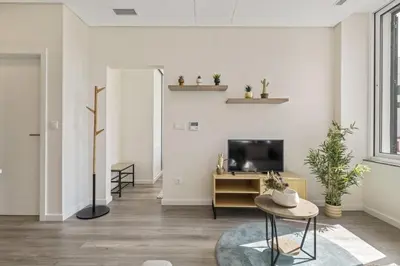 a living room with a tv and a table at Carmo Charm Apartment by Homie in Funchal