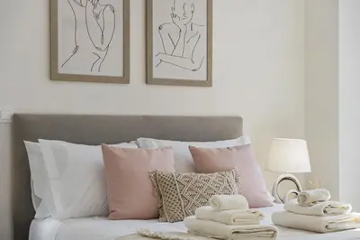 a bedroom with a bed with pink and white pillows at Carmo Charm Apartment by Homie in Funchal