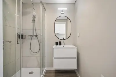 a bathroom with a shower and a sink and a mirror at Carmo Charm Apartment by Homie in Funchal