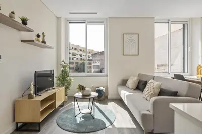 a living room with a couch and a tv at Carmo Charm Apartment by Homie in Funchal