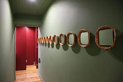 a room with a row of mirrors on a wall at 29 Madeira Hostel in Funchal