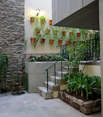 a staircase with potted plants on the side of a building at 29 Madeira Hostel in Funchal