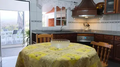 a kitchen with a table with a bowl on it at Quinta do Carmo house with View in Calheta