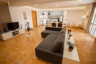 a large living room with a couch and a table at Slowing Villas - Villa Âncora in Porto Santo