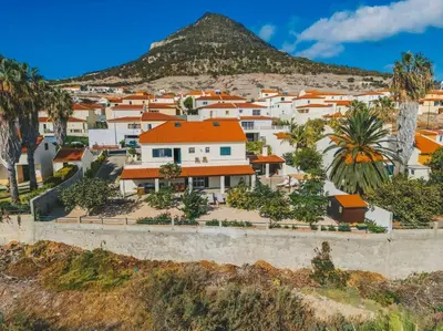 a group of houses on a hill with a mountain at Slowing Villas - Villa Âncora in Porto Santo