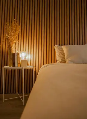 a bedroom with a bed and a table with a lamp at Slowing Villas - Villa Âncora in Porto Santo