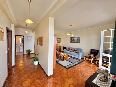a living room with a couch and a table at Moradia Abreu in Santa Cruz