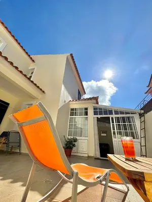 an orange chair sitting in front of a building at Moradia Abreu in Santa Cruz
