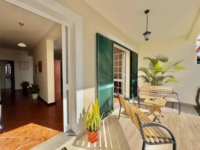 a living room with a bench and a table at Moradia Abreu in Santa Cruz