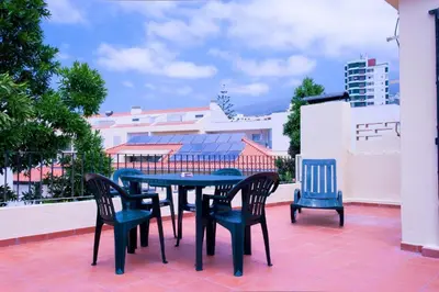 a table and chairs sitting on a patio at Hostel Monaco in Funchal