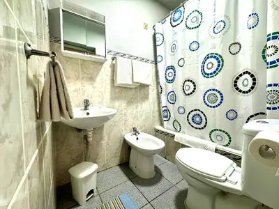 a bathroom with a sink and a toilet and a shower at Hostel Monaco in Funchal