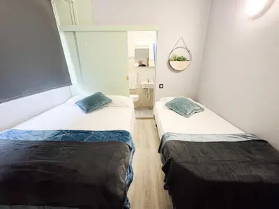 a room with two beds and a mirror at Hostel Monaco in Funchal