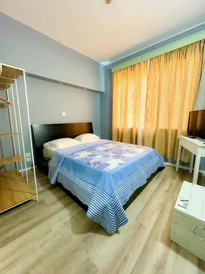a bedroom with a bed and a large window at Hostel Monaco in Funchal