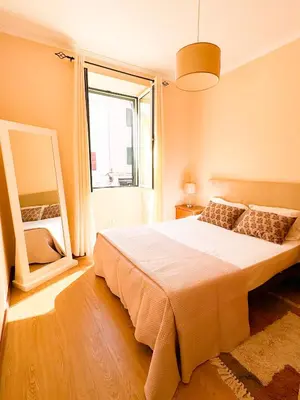a bedroom with a large bed and a large window at Hostel Monaco in Funchal
