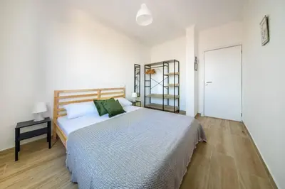 a bedroom with a bed in a white room at Casa das Virtudes by Mth in Funchal
