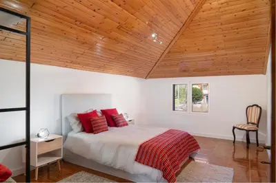 a bedroom with a bed and a wooden ceiling at OurMadeira - Prazeres Paradise in Prazeres