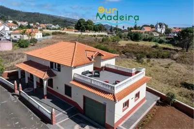 a house with an orange tile roof on top of it at OurMadeira - Prazeres Paradise in Prazeres