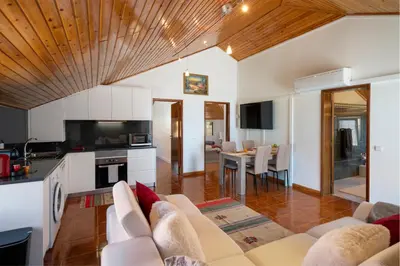 a kitchen and living room with a couch and a table at OurMadeira - Prazeres Paradise in Prazeres