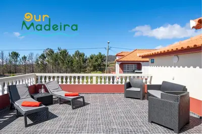 a patio with chairs and tables and a fence at OurMadeira - Prazeres Paradise in Prazeres