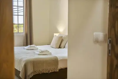 a bedroom with a bed with towels on it at Palm Tree House by Homie in Ponta Delgada