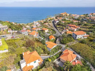 an aerial view of a small town next to the ocean at Palm Tree House by Homie in Ponta Delgada