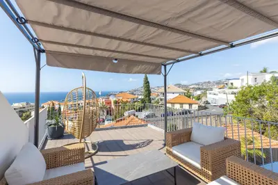 a balcony with a view of the ocean at Flowers island house 5 in Funchal