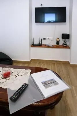 a book and a remote control sitting on a table at Casa Cabral by MTH in Ponta do Sol
