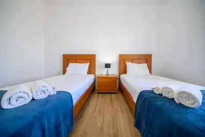 two beds in a room with towels on them at Casa Cabral by MTH in Ponta do Sol