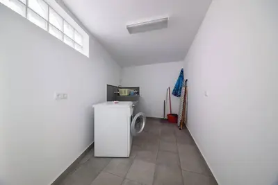 a kitchen with a white refrigerator in a room at Casa Cabral by MTH in Ponta do Sol