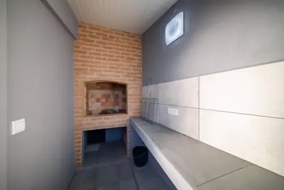 a room with a fireplace and a brick wall at Casa Cabral by MTH in Ponta do Sol