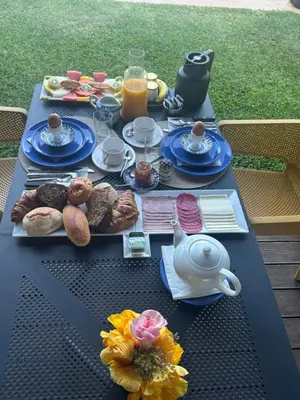 a table with food and drinks and a teapot at Suite Bela Vigia 3 in Jardim do Mar