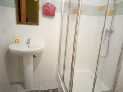 a bathroom with a sink and a shower at Costa Lodges, Funchal or Santa Cruz Madeira, shared room in Santa Cruz