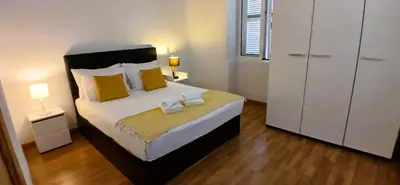 a bedroom with a large bed with yellow pillows at Sea House in Funchal