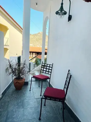 two chairs and a table on a balcony at K&K Apartments in Machico
