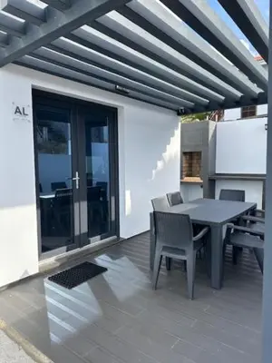 a patio with a table and chairs on a building at Casa dos Anjos in Vila do Porto