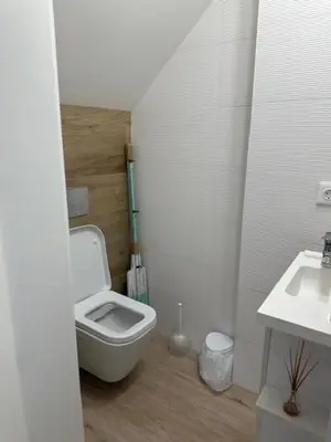 a bathroom with a toilet and a sink at Casa dos Anjos in Vila do Porto