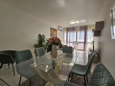 a living room with a glass table and chairs at Vista Mar Forum by Rentallido in Funchal