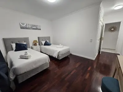 a hotel room with two beds and a couch at Vista Mar Forum by Rentallido in Funchal