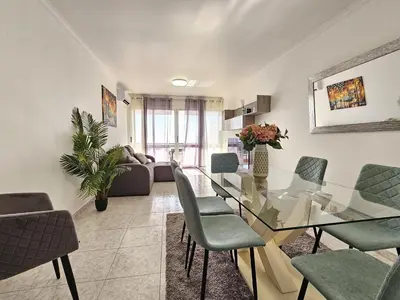 a living room with a glass table and chairs at Vista Mar Forum by Rentallido in Funchal