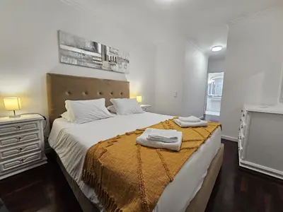 a bedroom with a large bed with two towels on it at Vista Mar Forum by Rentallido in Funchal