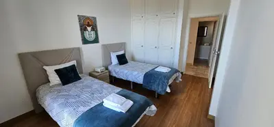a small room with two beds in a room at Margarita House in Funchal
