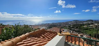 a view of the ocean from the roof of a house at Margarita House in Funchal