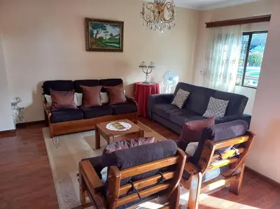 a living room with a couch and a table at Casa Afonso a getaway apartment in Arco da Calheta