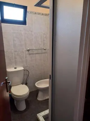 a small bathroom with a toilet and a sink at Casa Afonso a getaway apartment in Arco da Calheta