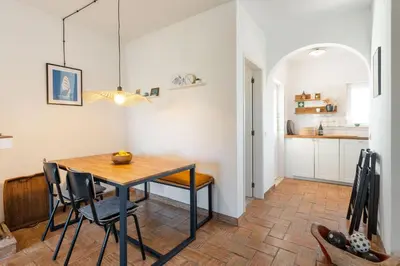 a kitchen and dining room with a table and chairs at Casa Matea in Figueira