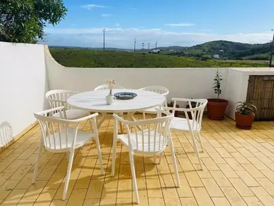 a white table and chairs on a patio at Casa Matea in Figueira