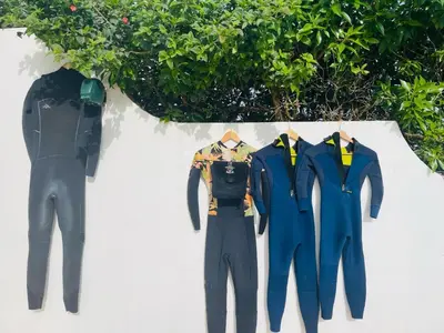 three man suits hanging on a wall at Casa Matea in Figueira