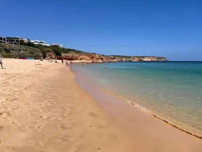 a beach with a group of people in the water at Casa Matea in Figueira
